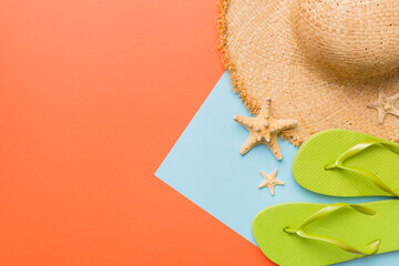Summer vacation concept flat lay. straw hat beach accessories and flip flop top view. Space for...