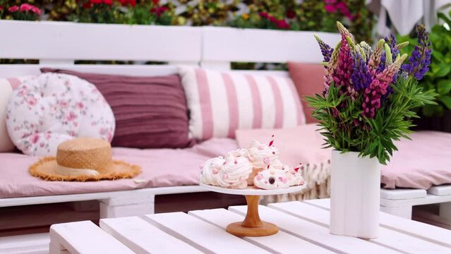 lupine flower bouquet on the pallet furniture on garden patio