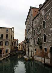 Venice canal view. Colorful facades, boats, calm river water. Beautiful architecture of Italy. Most romantic travel destinations. 