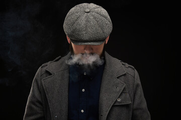 Man with a beard on a dark background, English classic clothes