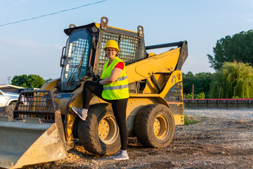 female construction worker driving earth mover - Powered by Adobe