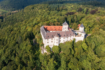 Fototapeta na wymiar Bird's-eye view of the Greifenstein Castle in the middle of a forest in Upper Franconia/Germany