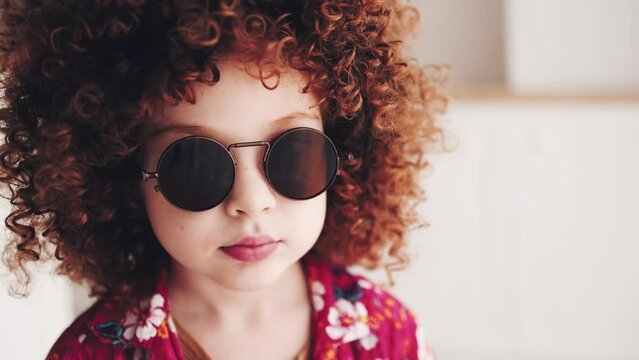 facial portrait of redhead curly kid in sunglasses