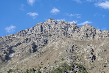 View of the mountains without snow in summer, blue sky on the background of the mountain