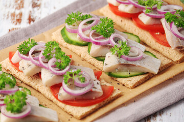 Sandwiches with herring and vegetables