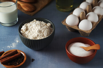 Food ingredients for baking: flour, eggs, milk, sugar	