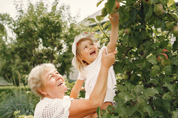 Grandmother and granddaughter enjoyed in the garden
