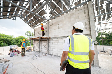 Engineers and architects supervise the construction of houses on residential construction sites.