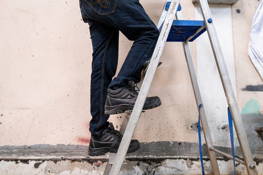 worker on the roof - Powered by Adobe