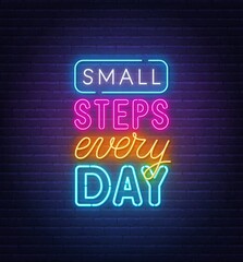 Small steps every day neon quote on a brick wall.
