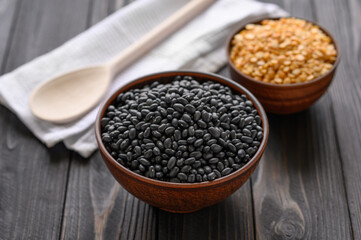 Fresh organic natural beans and peas on wooden rustic black background