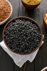 Fresh organic natural beans on wooden rustic black background