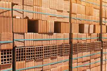 Pallets with freshly made racks of bricks at a construction site or near an industrial plant. Storage of building materials at the warehouse