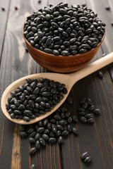 Fresh organic natural beans on wooden rustic black background
