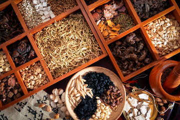 Chinese herbal medicine and flower tea on wooden