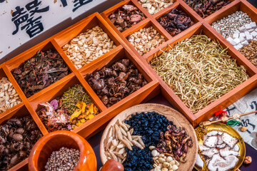 Chinese herbal medicine and flower tea on wooden