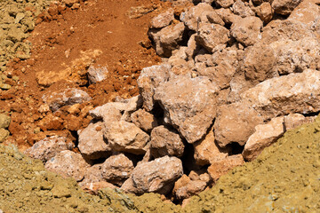Accumulation of very dry earth with earthy colors, predominantly ocher and pink.