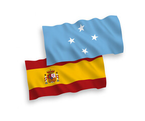 National vector fabric wave flags of Federated States of Micronesia and Spain isolated on white background. 1 to 2 proportion.