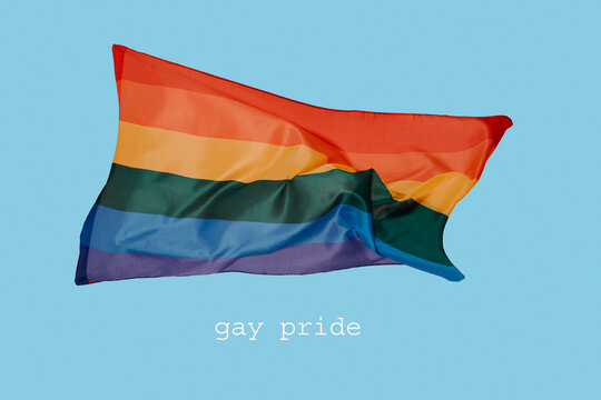 rainbow flag and text gay pride on blue background