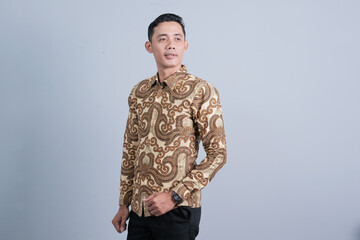 Attractive Asian men have different emotions wearing Indonesian batik clothes