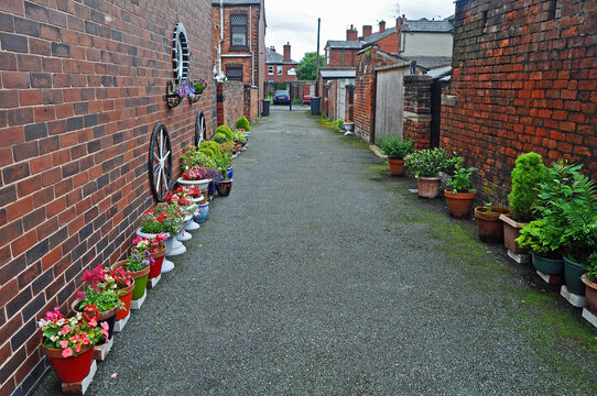 Backstreet Britain showing a pretty Entry or Ginnel with potted plants and flowers in the U.K. demonstrating what can be done with a little imagination 