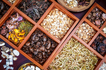 Chinese herbal medicine and flower tea on wooden