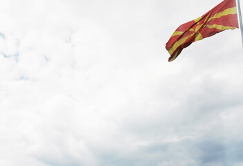 Flag of Macedonia (FYROM) Waving against a cloudy sky. Clean background with place for text.