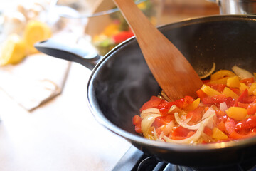 Cooking fresh vegetables in frying pan on stove, closeup. Space for text