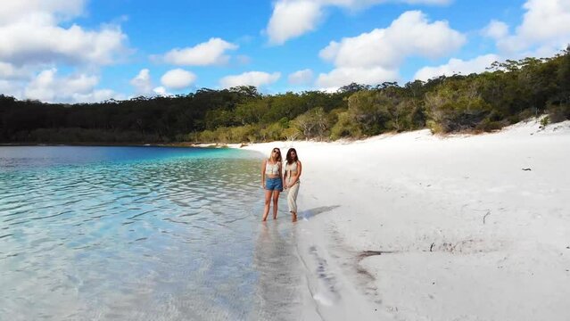 Drone view of two young woman friends on the Lake Mackenzie in Fraser Island
