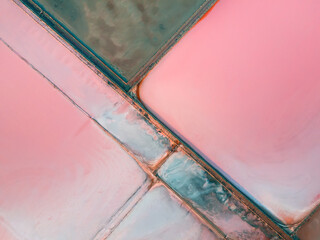 Salt industry with colorful salt and water surface. Aerial top down view. Abstract nature...