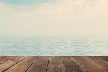 Fototapeta na wymiar Empty wooden table near sea. Summer season