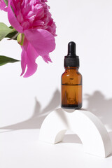 Glass dropper bottle with peony flowers. Hyaluronic acid oil, serum with collagen and peptides skin...