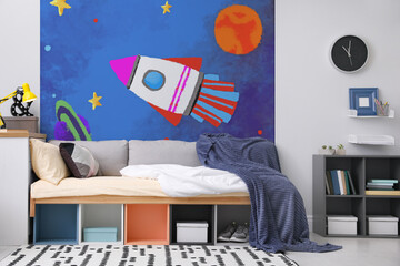 Beautiful wallpaper with image of rocket in teenager's room interior
