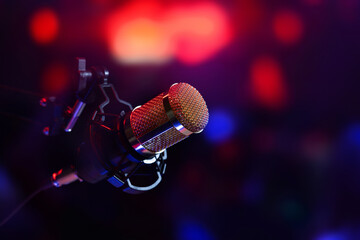 studio microphone in neon lights. sound recording equipment - obrazy, fototapety, plakaty
