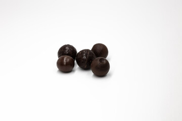 Different small spherical brown chocolates on a white background isolated