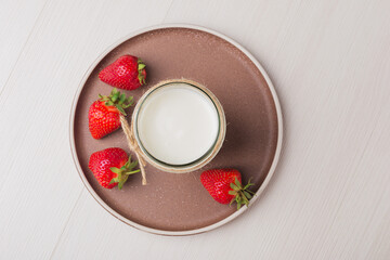Homemade Greek yogurt in a glass jar ready to eat. Healthy breakfast.