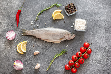 Raw trout fish on stone background