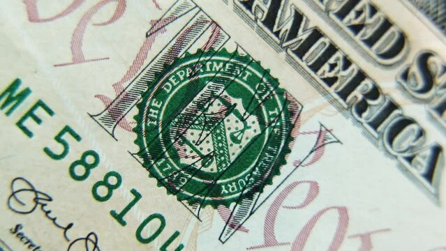 A ten-dollar paper bill rotates in close-up. 