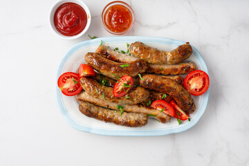 Overhead view of grilled sausages and sauces