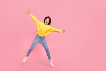 Fototapeta na wymiar Full body photo of young cheerful woman have fun jumper fly wear casual outfit isolated over pink color background