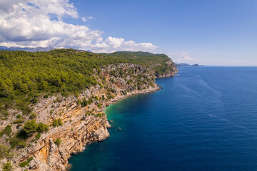 Fototapeta na wymiar Aerial view of the Pasjaca cliff and beach, blue sea and mountains, Croatia