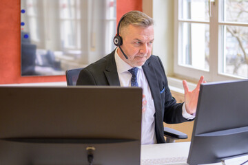 Determined businessman on a teleconference call in office