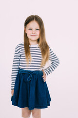 Adorable smiling little girl in dress isolated on a white background