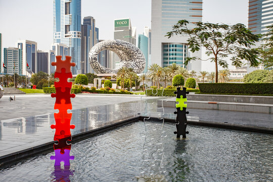 DUBAI, UAE - April 17, 2022: DIFC Sculpture Park, multi-colored composition of puzzles, Jumeirah Emirates Towers, Museum of The Future, Voco.