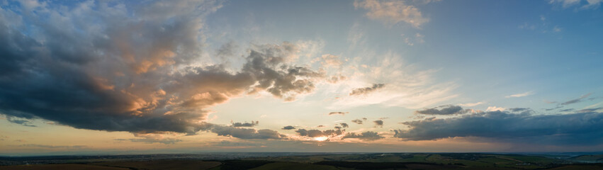 Bright colorful sunset sky with setting sun and vivid soft clouds. Concept of nature and environment