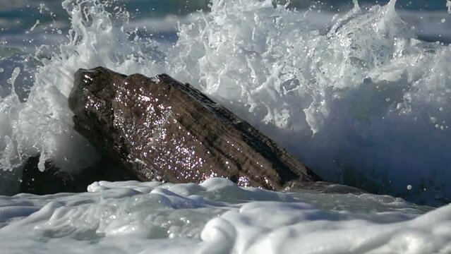 Wave crushing rock , Ocean Beautiful Wave splashing. Water foam slow-motion