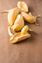 jackfruit flesh with seeds on a wooden surface, tropical health beneficial fruit native to southeast asia, taken in shallow depth of field with copy space © Shamil