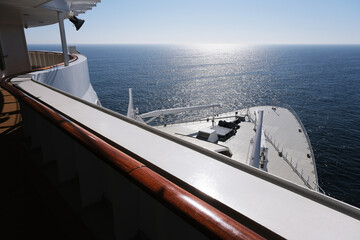View from open decks of legendary luxury ocean liner  cruise ship on sunny day twilight sunset...