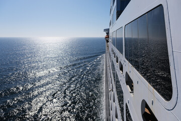View from open decks of legendary luxury ocean liner  cruise ship on sunny day twilight sunset...