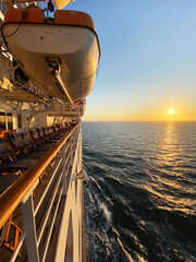 View from open decks of legendary luxury ocean liner  cruise ship on sunny day twilight sunset...